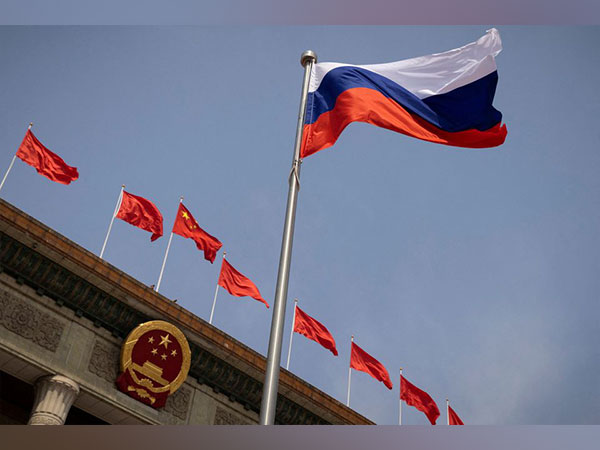 The Russian national flag flies in front of the Great Hall of the People. (Image Credit: Reuters)