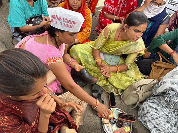 Selected woman candidate for government primary teacher polishing shoes (Photo/ANI)