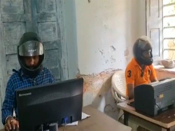 Telangana: Government officials wear helmets at office (Photo/ANI)