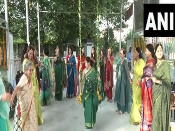 Women dressed in green singing Teej songs. (Photo/ANI)