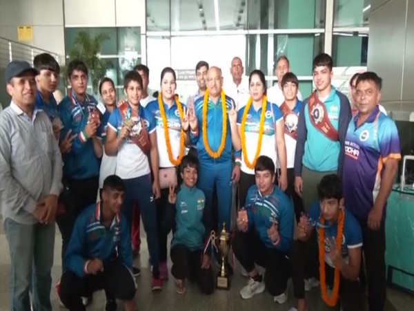 Women's wrestling team posing with trophy. (Photo- ANI)