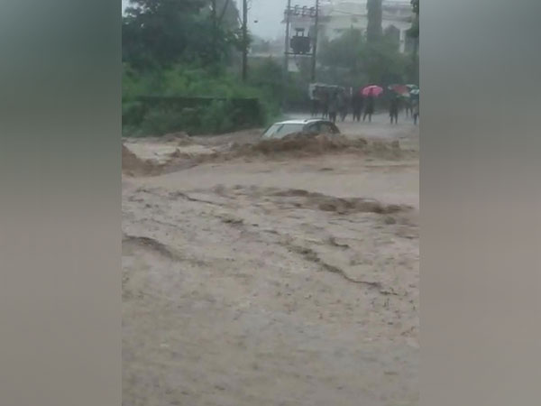 A car stuck in the river in Uttarakhand. (Photo/ANI)