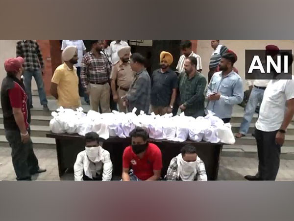 Accused along with seized heroin (Photo/ANI)