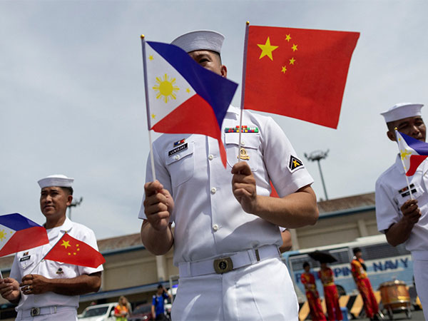 Philippine Navy personnel with national flags of China and the Philippines. (File Photo/Reuters)