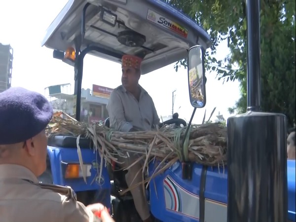 Visuals of Independent MLA Umesh Kumar with sugarcane tractor outside Uttarakhand Assembly (Photo/ANI)