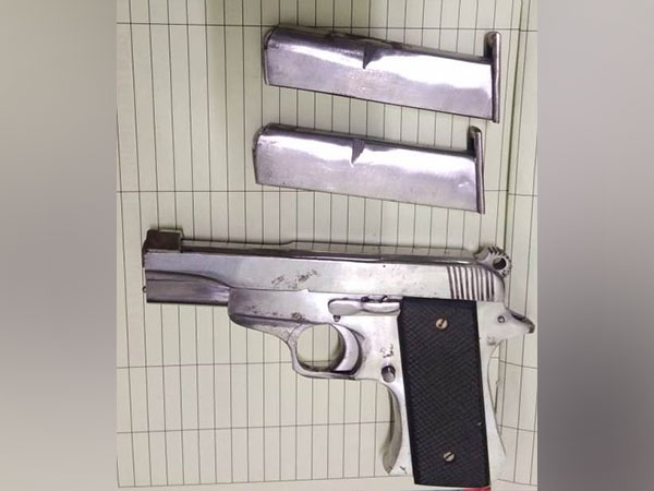 Country made Pistol along with two empty magazines seized from passenger at Delhi airport. (Photo/ANI)