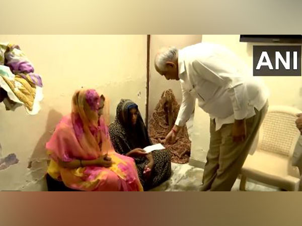 Gujarat CM hands over Rs 1 cr cheque to family members. (Photo/ANI)
