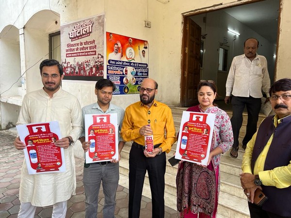 Congress leaders with posters and bottle of Gangajal (Photo/ANI)
