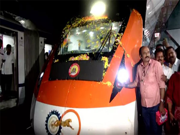 People posing with Vande Bharat Express train at Thiruvananthapuram Central Station (Photo/ANI)