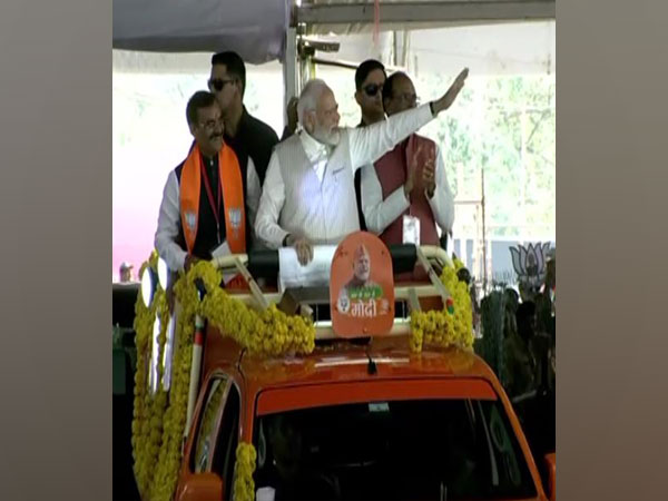 PM Modi greets people at Jamboree Maidan in Bhopal. (Photo/ANI)