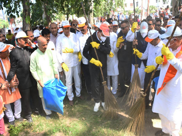 CM Pushkar Singh Dhami taking part in a cleanliness drive (Photo/ANI)
