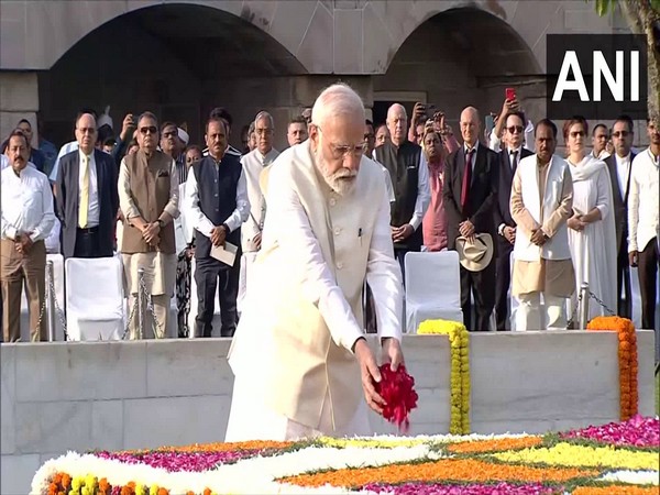 Prime Minister Narendra Modi pays floral tribute to Gandhi at Rajghat, Delhi. (Photo/ANI)