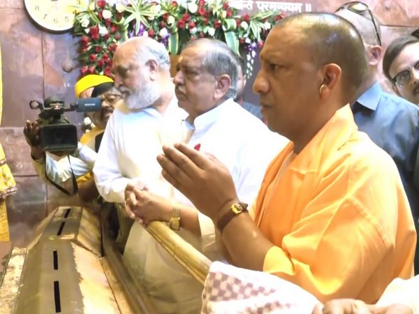 Chief Minister Yogi Adityanath while offering prayers at Shri Banke Bihari Temple (Photo/ANI)