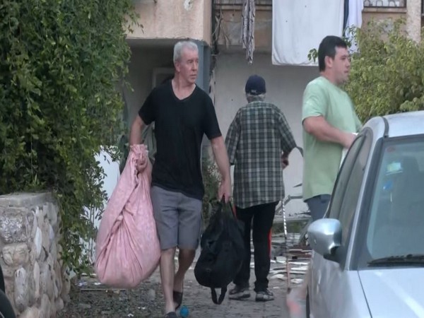 People flee residential buildings after Hamas launches rocket attack in southern Israel (Photo/ANI)