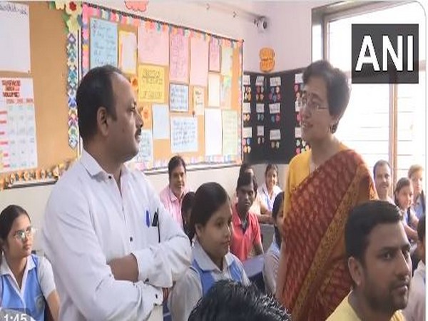 Delhi Education Minister Atishi interacts with a parent during the PTM (Photo/ANI)