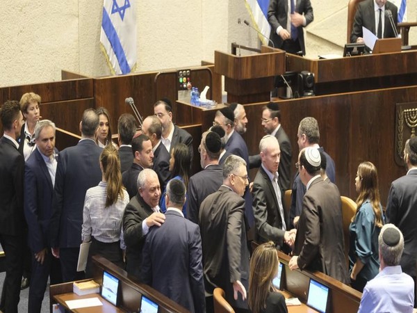 Knesset lawmakers in Jerusalem congratulate each other after Israel's emergency unity government was sworn in. (Photo/TPS)
