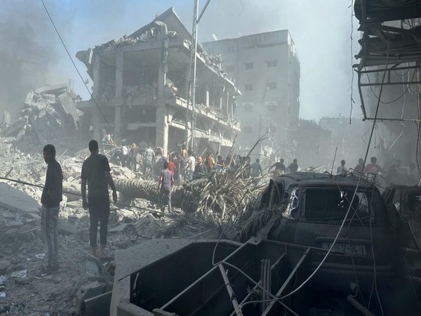 Palestinians in Gaza clear away rubble from an Israeli air strike (Photo/TPS)