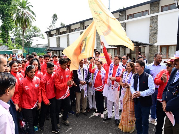 Uttarakhand Chief Minister flagging off players participating in 37th National Games (Photo/ANI)