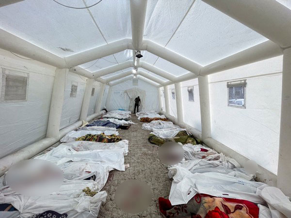 Bodies of Palestinians killed in Israeli strikes lie on the floor at a tent at Shifa hospital in Gaza City (Photo credit: Reuters)