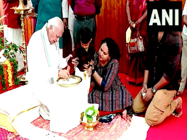 Kerala Governor Arif Muhammed Khan helps a child write first letter at Vidyarambham ceremony. (Photo/ANI)