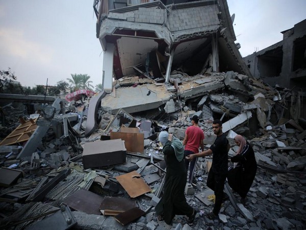 Palestinians in Deir al-Balah sort through the rubble of an Israeli air strike on terror facilities in the Gaza Strip (Photo/TPS)