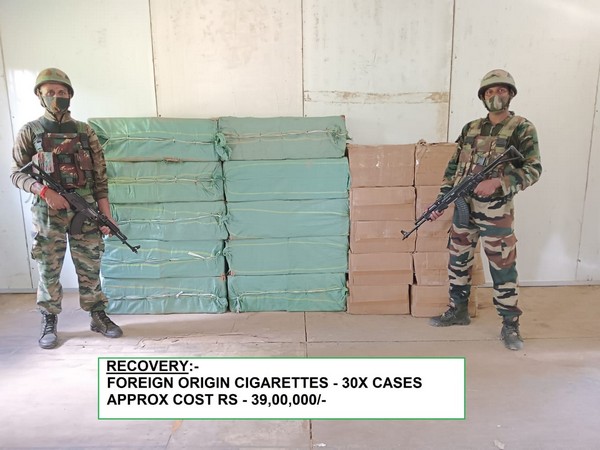 Jawan of Assam Rifles with recovered foreign origin cigarettes in background (Photo/Assam Rifles)