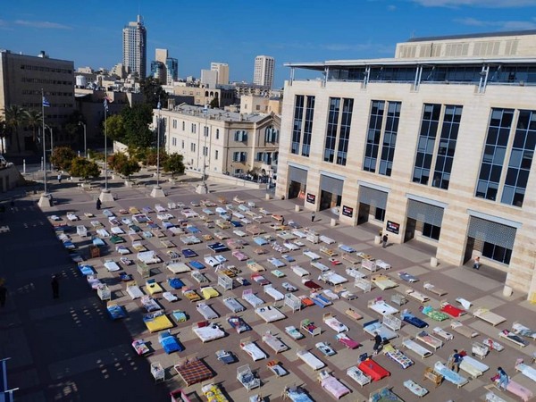 Members of Kibbutz Nir Oz in Jerusalem set up 239 empty beds symbolizing Israeli hostages (Image Credit: Itay Gross)