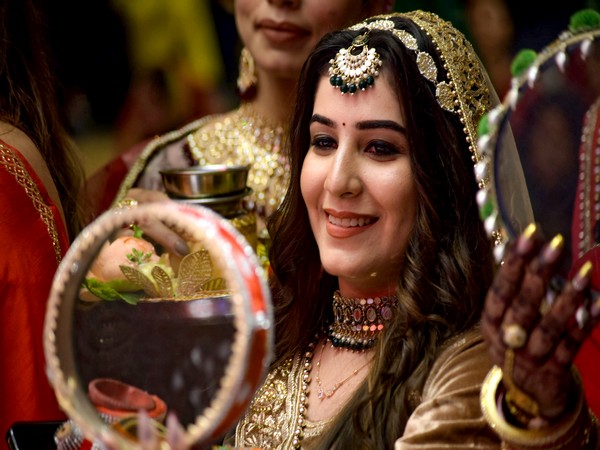 Visuals of a woman celebrating the festival of Karwa Chauth (Photo/ANI)  