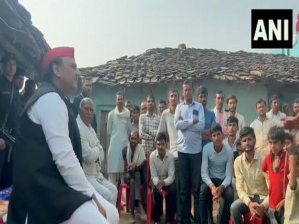 Akhilesh Yadav interacts with Dalit tribals in Surajpur village of Chandla constituency (Photo/ANI)