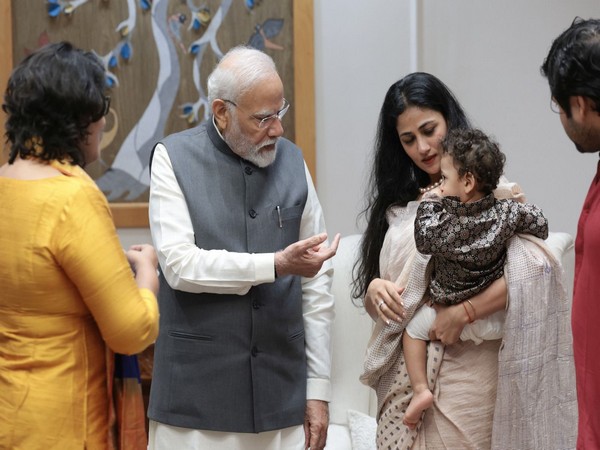 PM Narendra Modi makes a gesture to Karmanya. (Photo/ANI) 