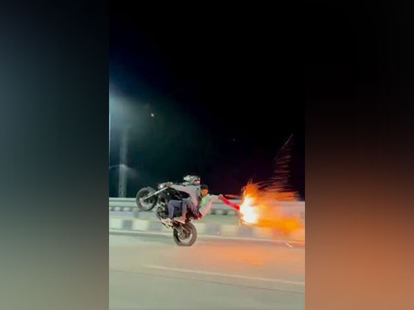 Bikers performing stunts and bursting firecrackers while riding motorcycles in Trichy. (Photo/ANI)