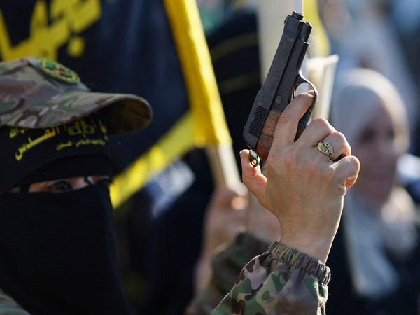 Palestinian Islamic Jihad militants participate in an anti-Israel military parade marking the 36th anniversary of the movement's foundation in Gaza City (Photo Credit: Reuters)