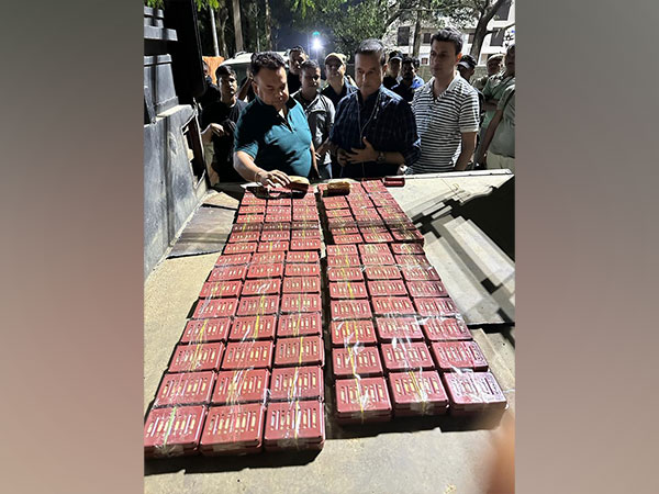 Assam police with the seized heroin. (Photo/ANI)