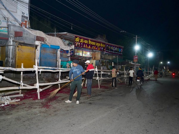 BJP workers cleaning the route of the roadshow (Photo/ANI)