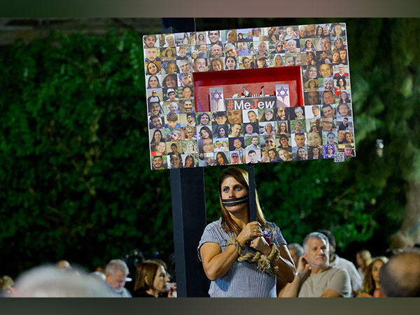People gather as they await news of hostages expected to be released by Hamas, in Tel Aviv (Photo Credit: Reuters)