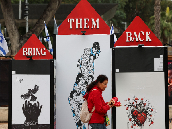 Woman walks past art installation aimed to draw awareness about hostage held by Hamas. (Photo Credit: Reuters)