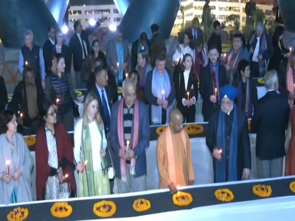 CM Yogi lighting the first lamp on Dev Diwali. (Photo/ANI)