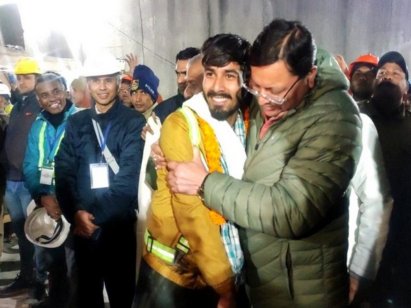 One of the rescued workers with Uttarakhand CM Pushkar Singh Dhami (Photo/ANI)