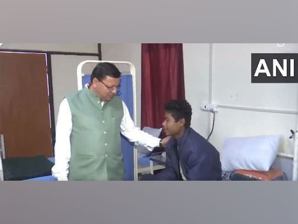 Chief Minister Pushkar Singh Dhami with a rescued worker during his visit to Chinyalisaur Community Health Centre (Photo/ANI)