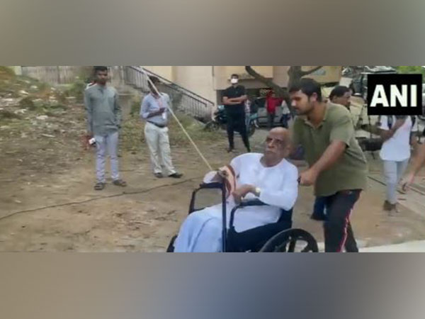 A wheel-chair voter being assisted by a volunteer to cast his vote at a polling booth in Telangana (Photo/ANI)