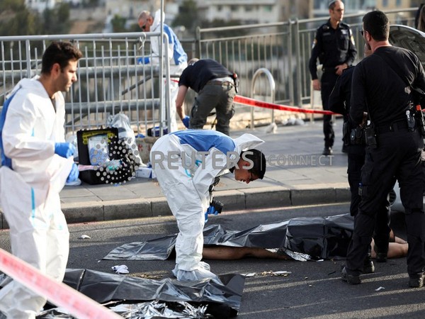 Israeli officials work at the scene of a violent incident in Jerusalem November 30 (Photo Credit: Reuters)