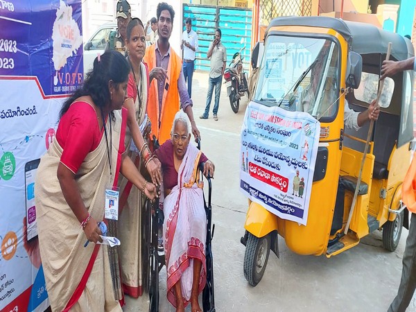 An elderly woman in a wheelchair is being assisted on her way to cast her vote at Kareembad (Photo/ANI)
