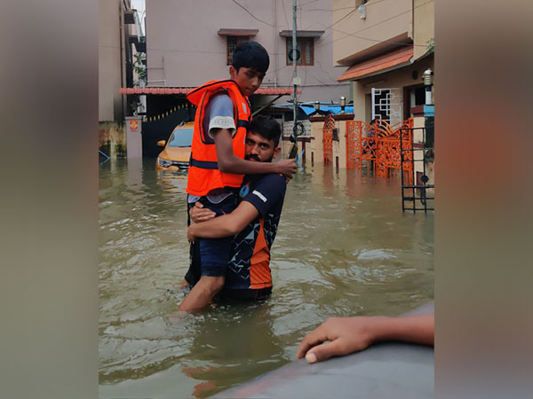 A young boy is evacuated from flooded area in Chennai (Photo/X @chennaicorp)