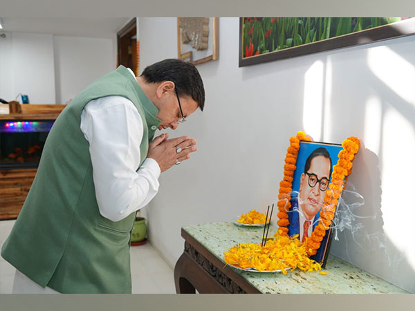 CM Dhami paying tribute to Dr Bhimrao Ambedkar at his official residence (Photo/ANI)