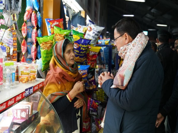 Chief Minister Pushkar Singh Dhami interacts with passengers at ISBT. (Photo/ANI)