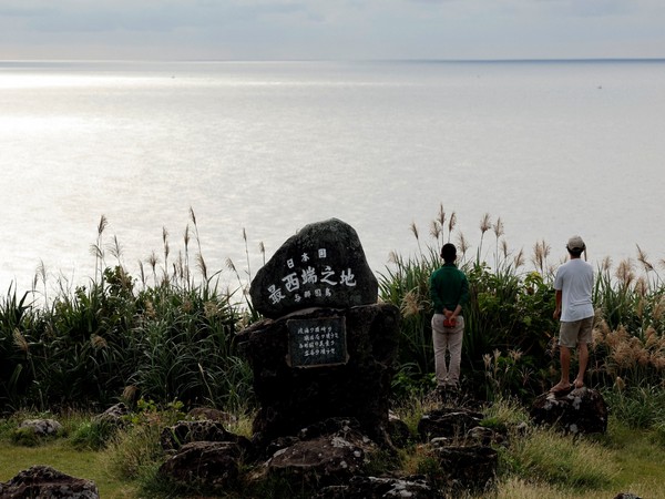 Visitors look on the East China Sea next to the monument for Japan's westernmost point on Yonaguni island, Okinawa (Photo/Reuters)