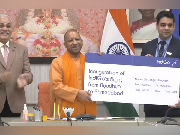 UP CM Yogi Adityanath receives the first boarding pass of flight to Ahmedabad from Ayodhya (Photo/ANI)