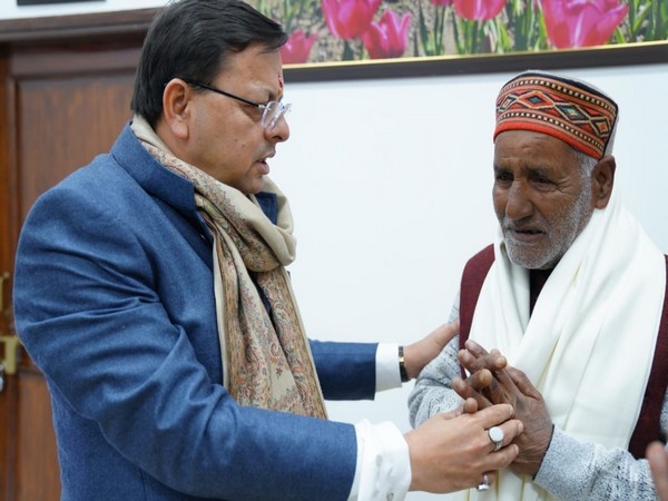 Uttarakhand CM Pushkar Singh Dhami meets late mountaineer Savita Kanswal's father. (Photo/ANI)