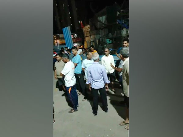 Locals gathered outside the building in Mumbai's Kandivali. (Photo/ANI)