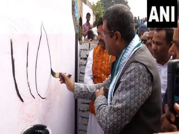 Union Education Minister Dharmendra Pradhan participating in BJP's 'Ek Baar Phir Se Modi Sarkar' wall writing programme (Photo/ANI)